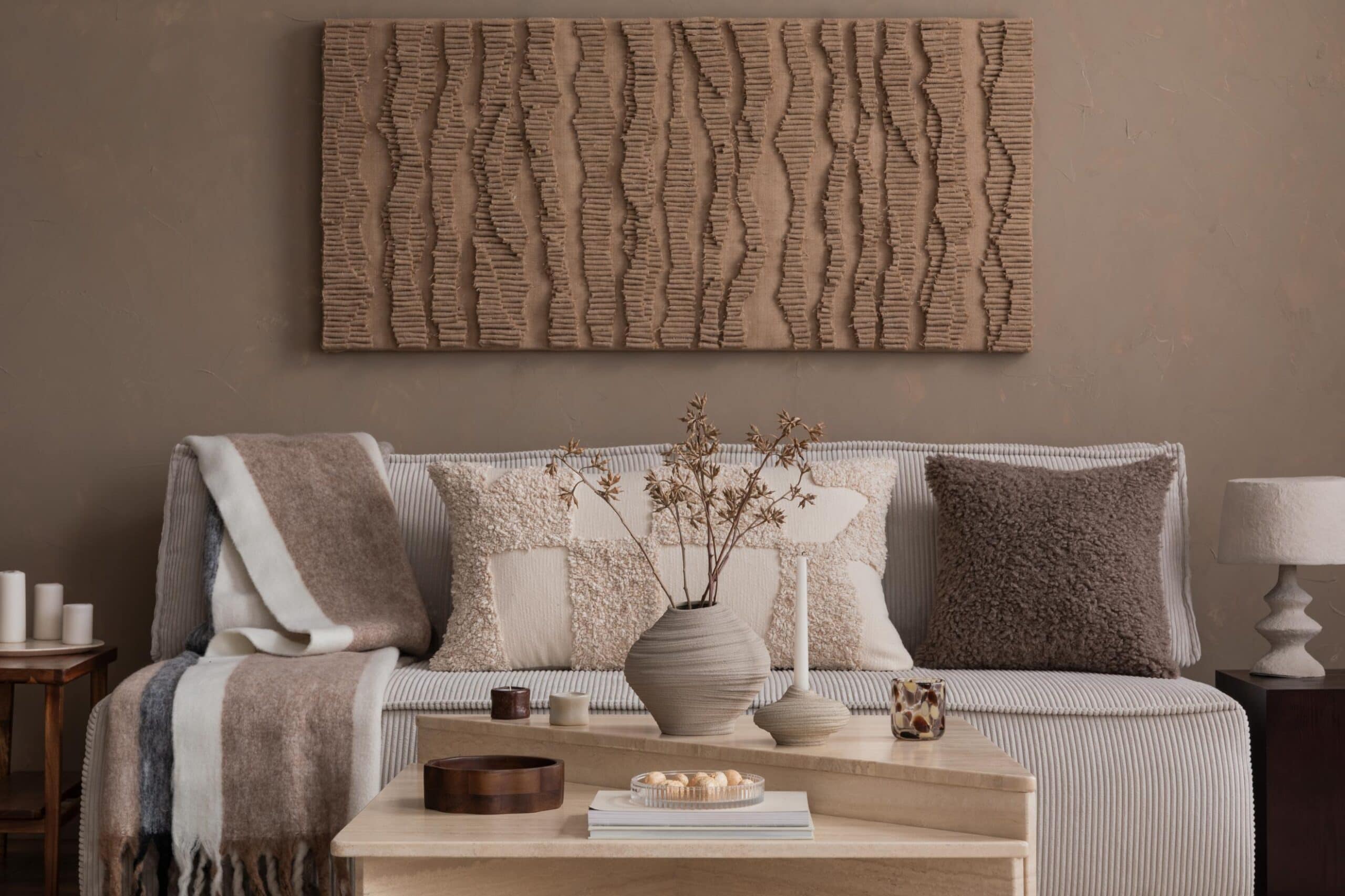 A living room with a couch, a coffee table and a rug