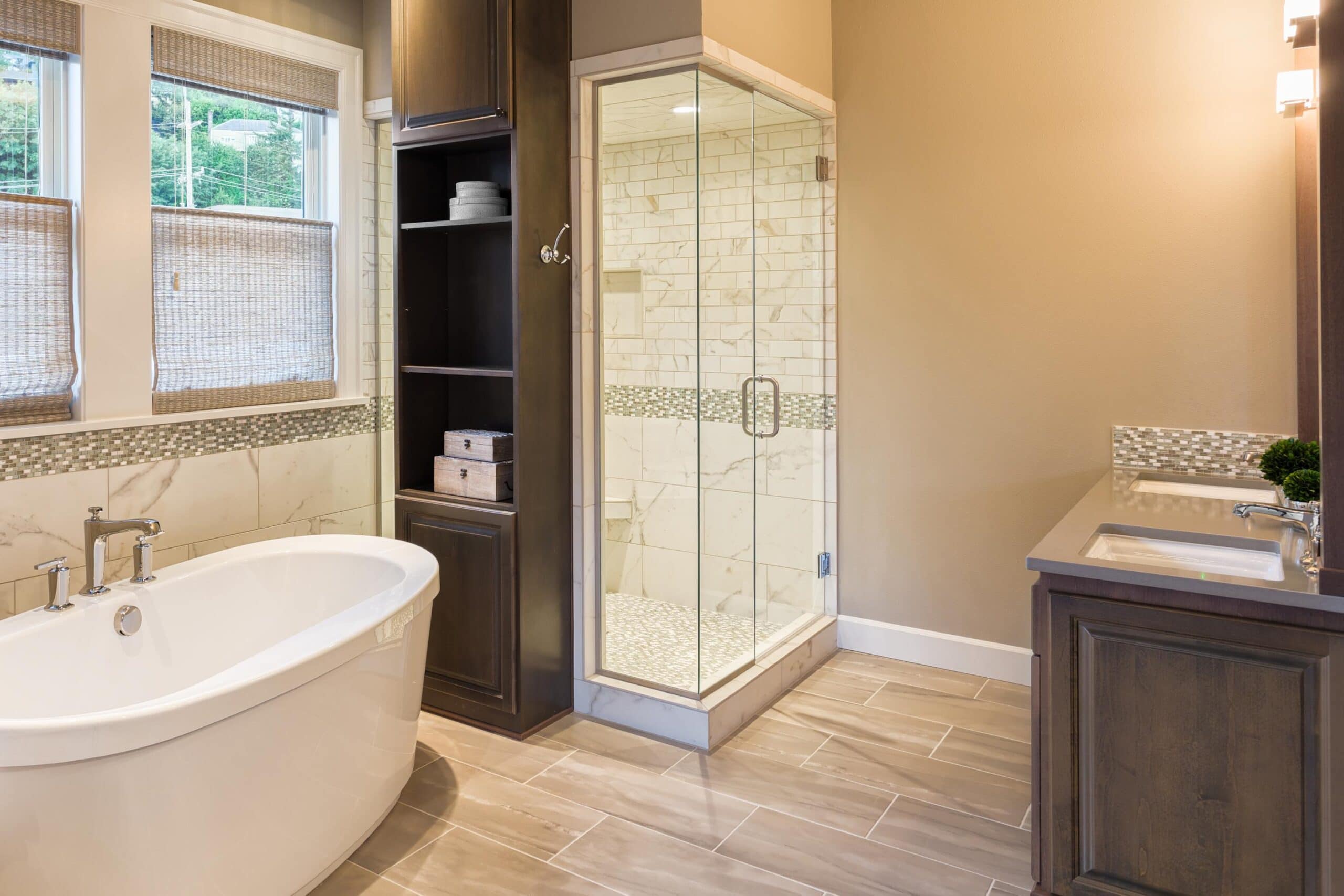 A large bathroom with a walk in shower and a tub